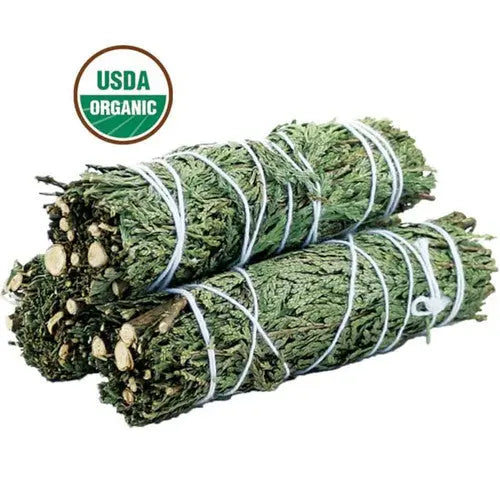 Two bundles of green herbs tied with twine on a white background, featuring an USDA Organic logo - Clover's Charm