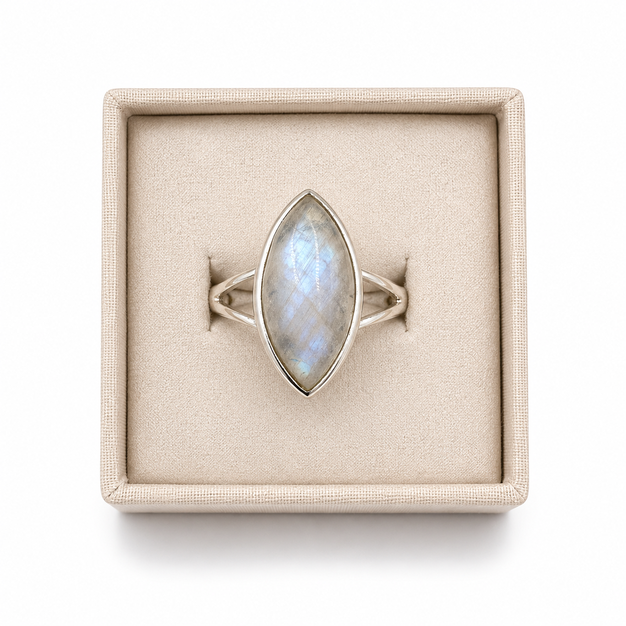 Sterling silver marquise moonstone ring with split shank displayed in a soft linen jewelry box on a white background -Cover's Charm.