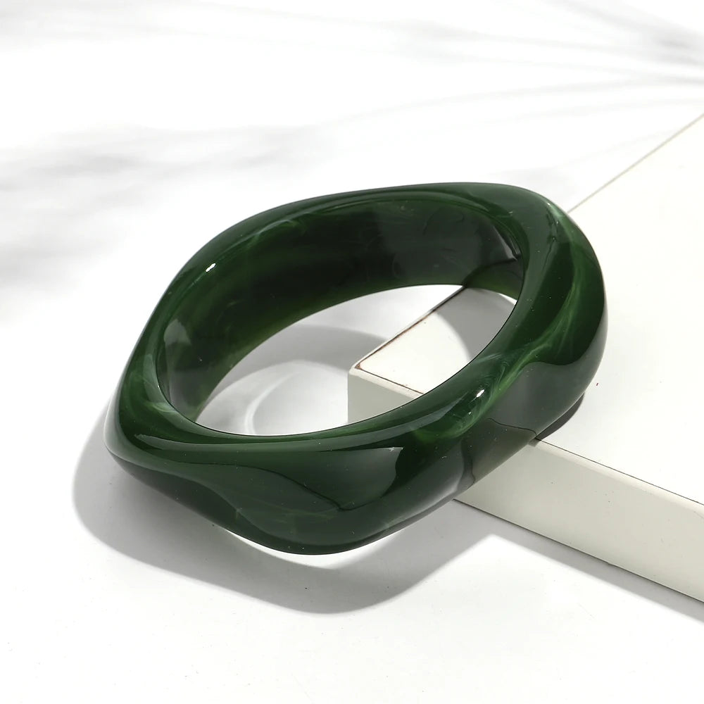 Green acrylic bangle on a white background