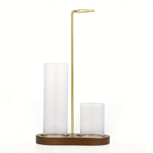 Modern candle light decor set with gold metal arm and two clear glass candle holders on a wooden base