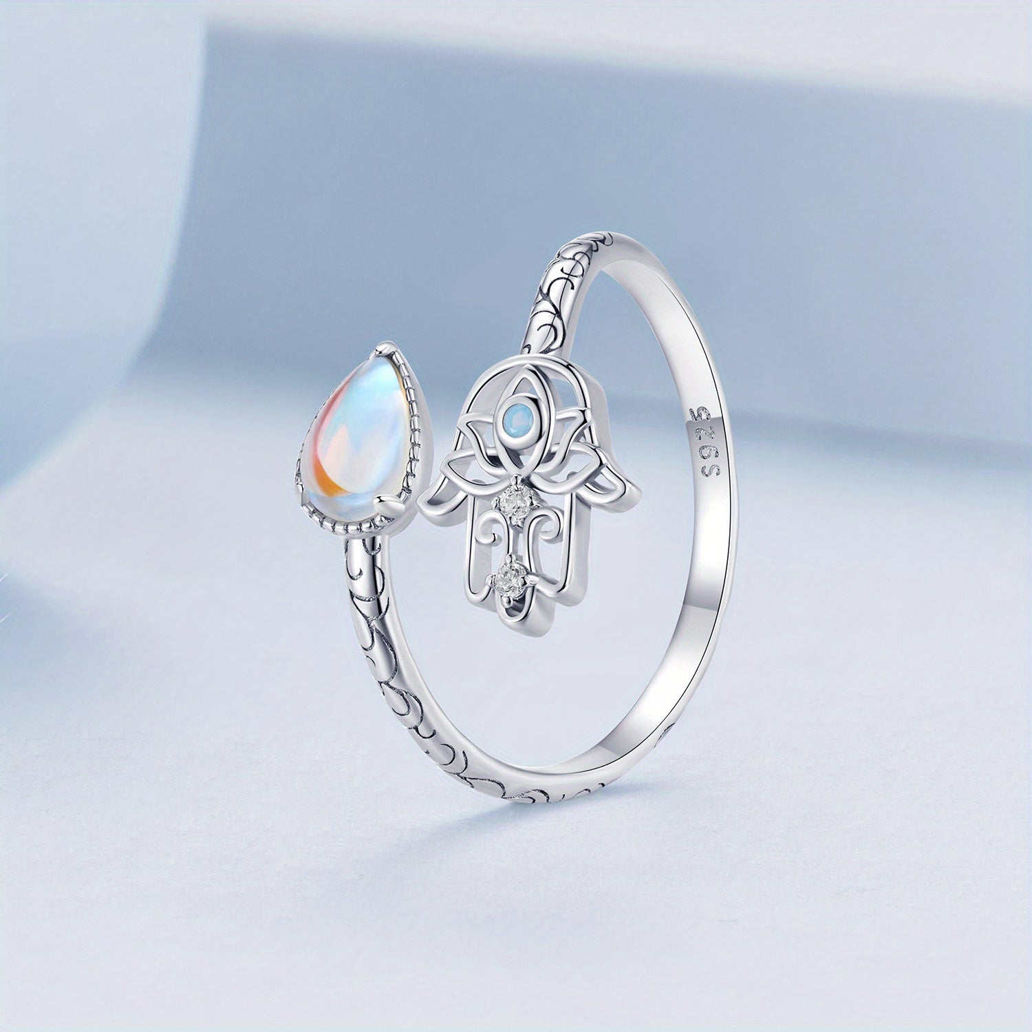 925 Sterling Silver Hamsa Wrap Ring – Zircon Palm Design Elegant Adjustable Ring on a soft blue background