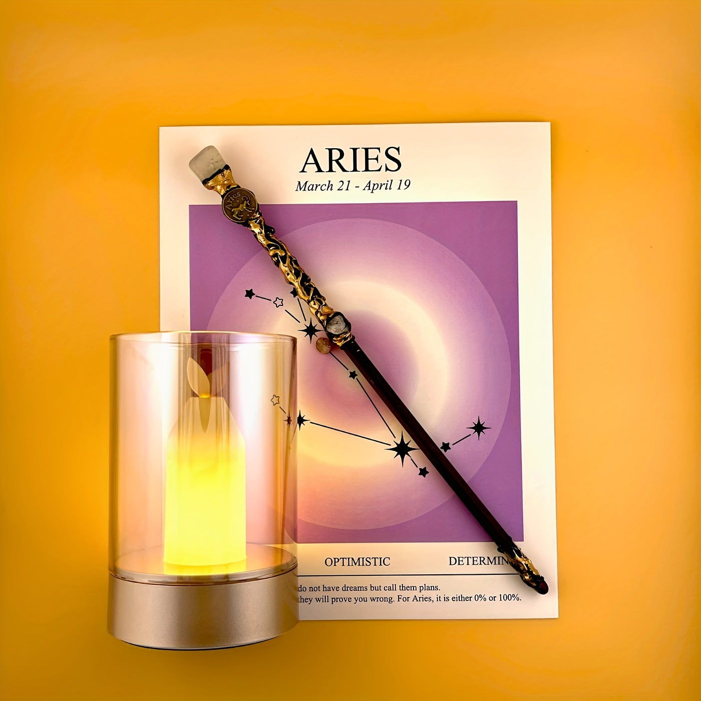 Aries zodiac art print with constellation design displayed beside a glass candle holder and decorative astrology wand on a warm yellow background