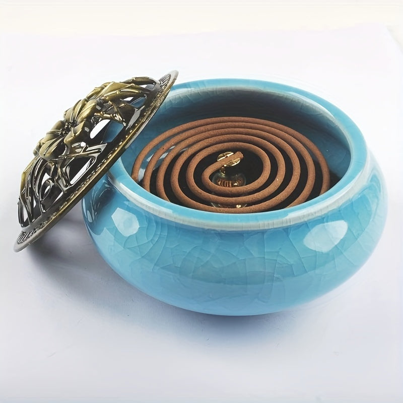 Blue ceramic incense burner with decorative metal lid displayed with the lid off on a wooden surface against a dark background for elegant home decor styling