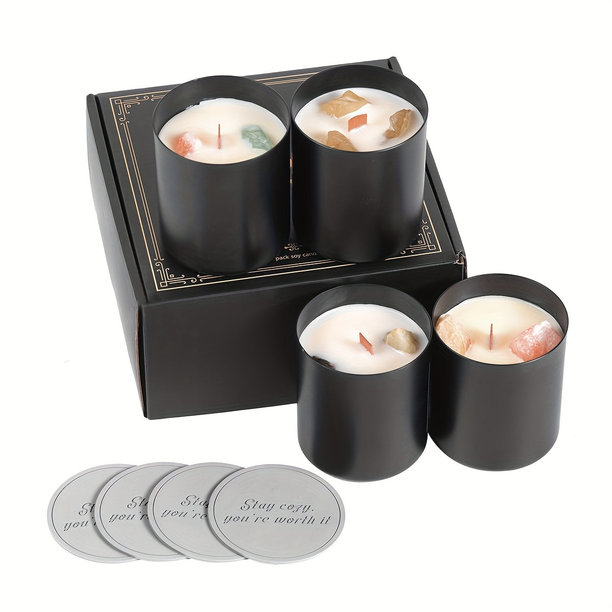 Set of four black candles in a decorative box with coasters on a white background