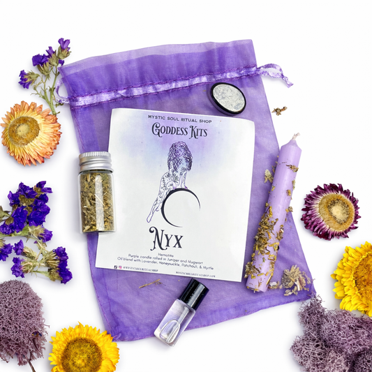 Goddess Kits Nyx packaging with purple drawstring bag, candle, and herbs surrounded by flowers on a white background.