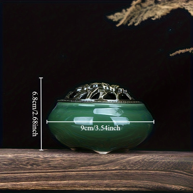 Green ceramic incense burner with decorative metal lid displayed on a wooden surface against a dark background for elegant home decor styling