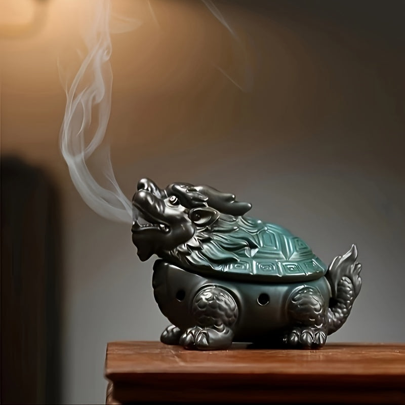Decorative ceramic dragon incense burner with detailed sculpted finish sitting on a table , smoke coming out of it's mouth, neutral background. 