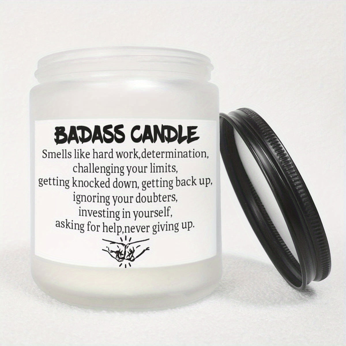 Humorous novelty candle in glass jar with bold quote label, lid off, white background.