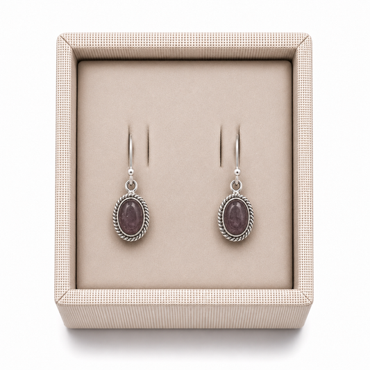 Sterling Silver Bezeled Oval Rose Quartz Dangle Earrings in a decorative box on a white background -Clover's Charm. 