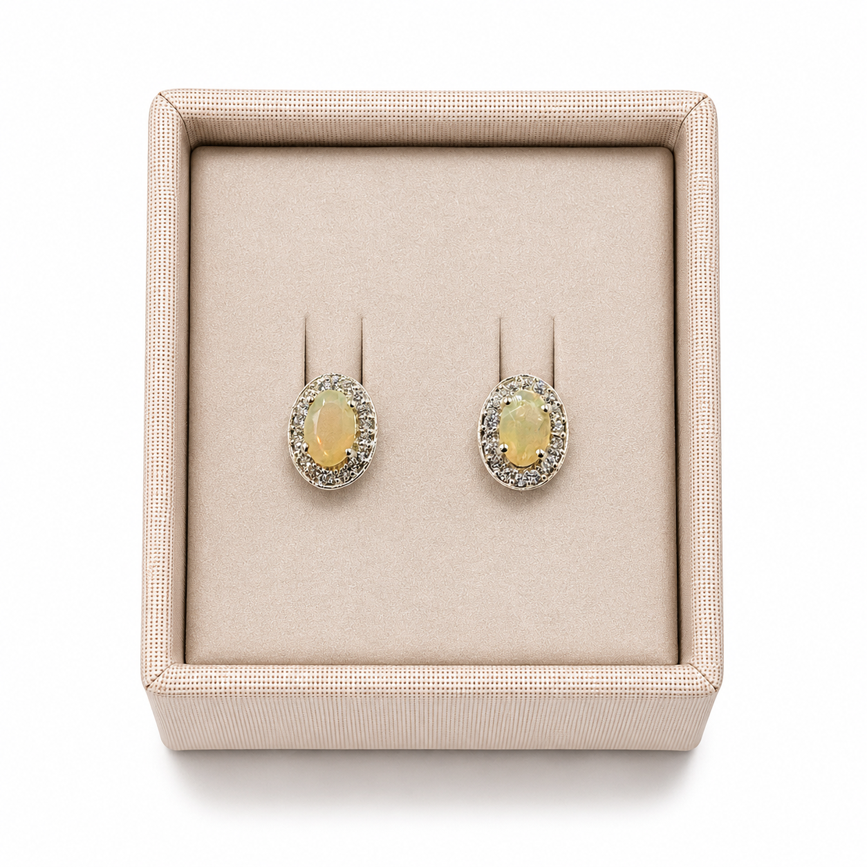 Sterling silver opal stud earrings displayed in a soft linen jewelry box on a white background with a luxury retail presentation -Clover's Charm.