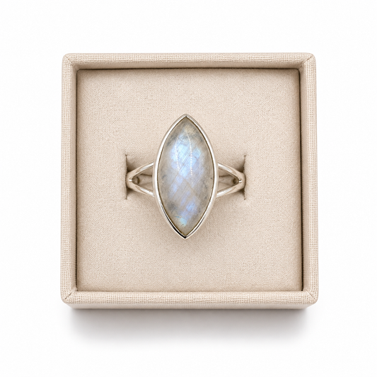 Sterling silver marquise moonstone ring with split shank displayed in a soft linen jewelry box on a white background -Cover's Charm.
