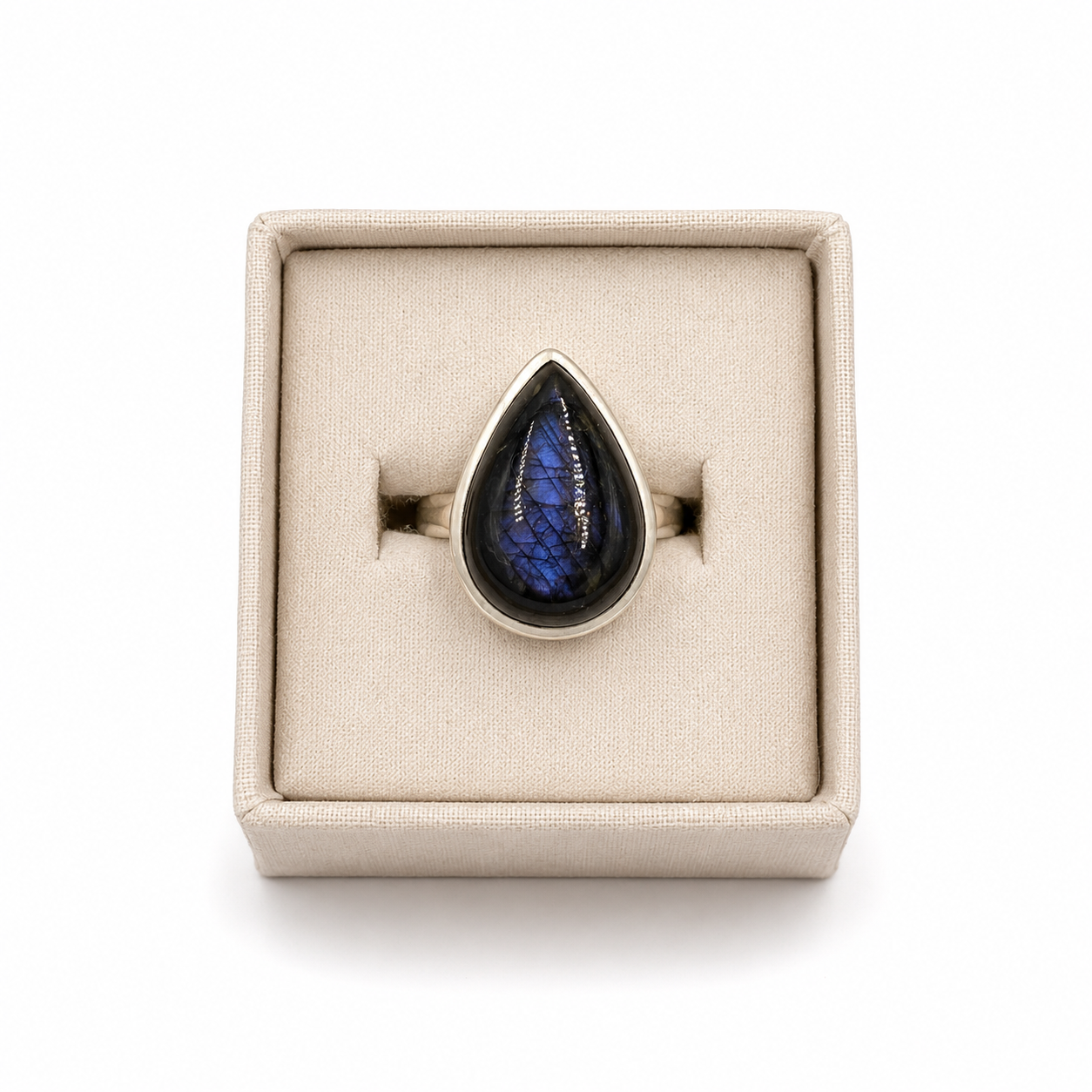 sterling silver teardrop shaped spectrolite ring  in a small jewelry box on a white background -Clover's Charm.