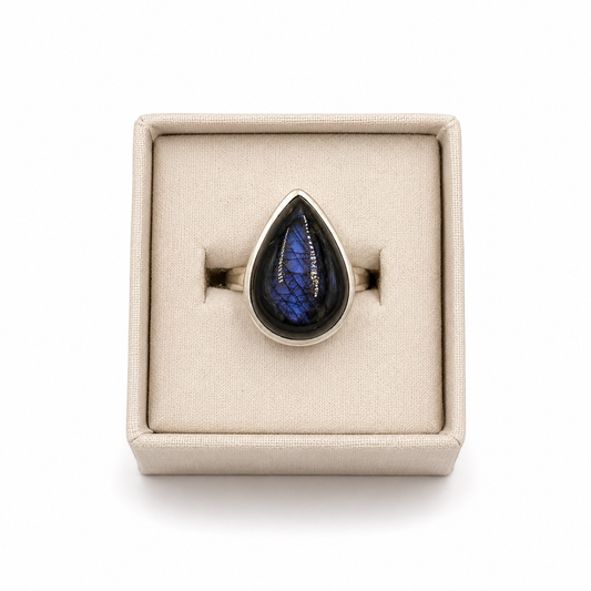 sterling silver teardrop shaped spectrolite ring  in a small jewelry box on a white background -Clover's Charm.