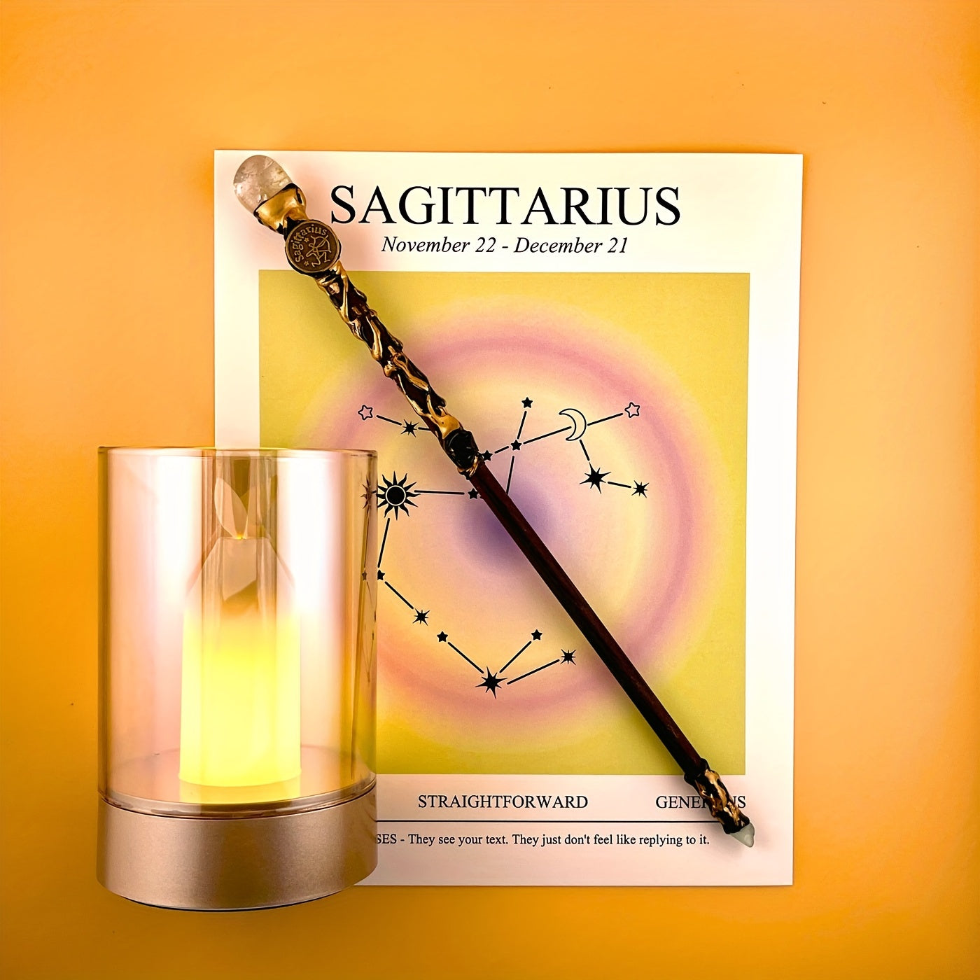 Sagittarius zodiac art print with constellation design displayed beside a glass candle holder and decorative astrology wand on a warm yellow background
