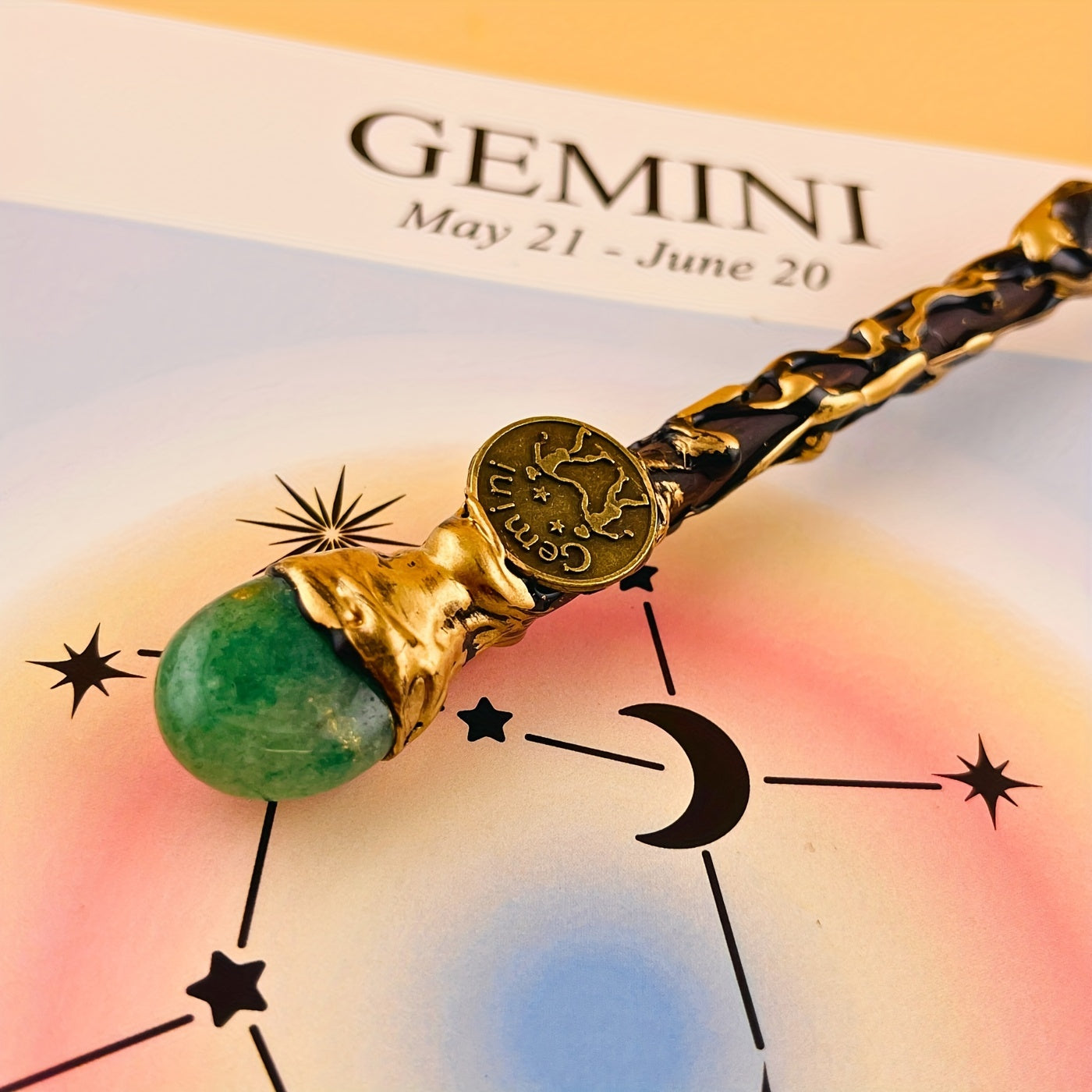 Gemini zodiac art print with constellation design shown with a decorative astrology wand featuring green stone detail on a warm background