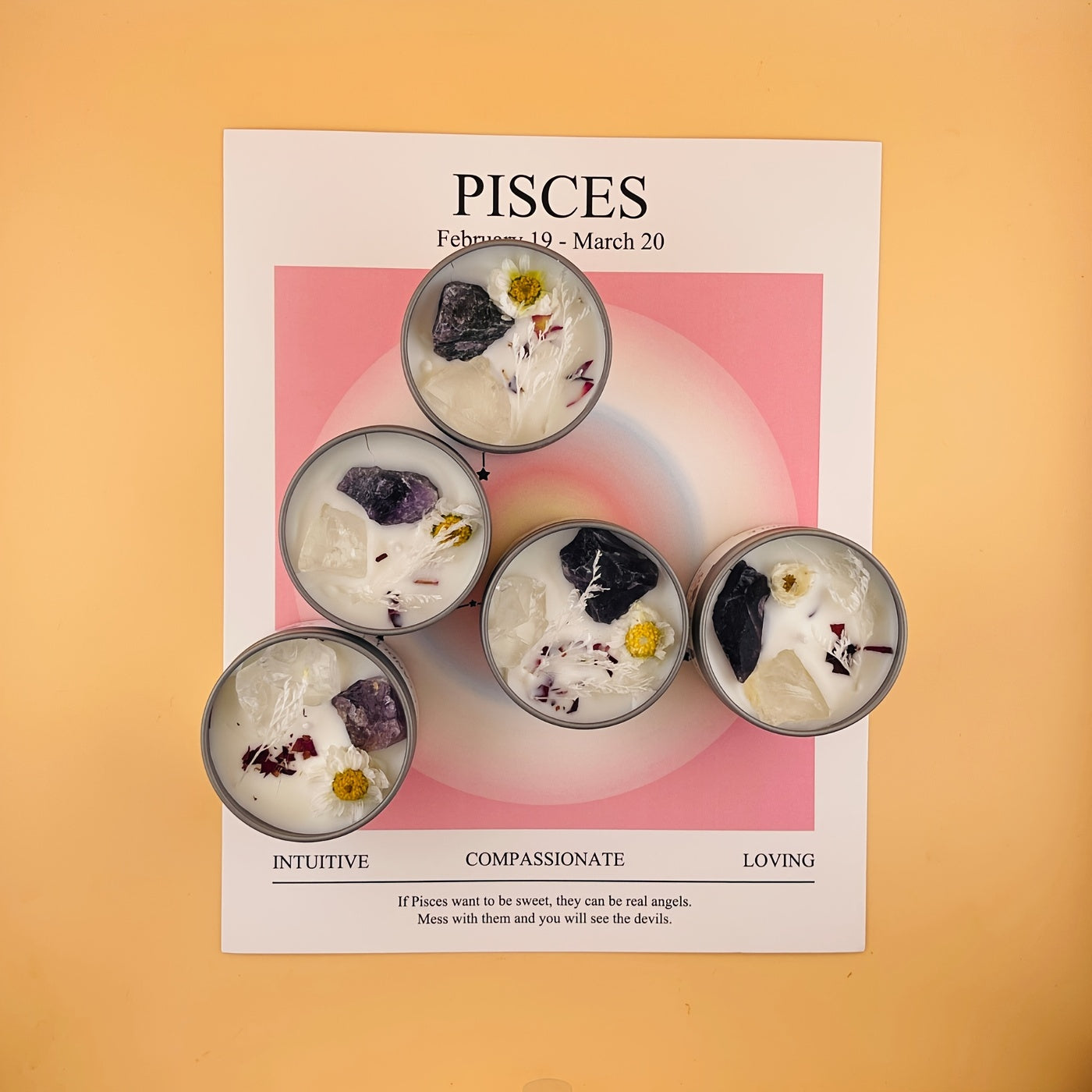 Pisces zodiac sign with five decorative candles on a pink background