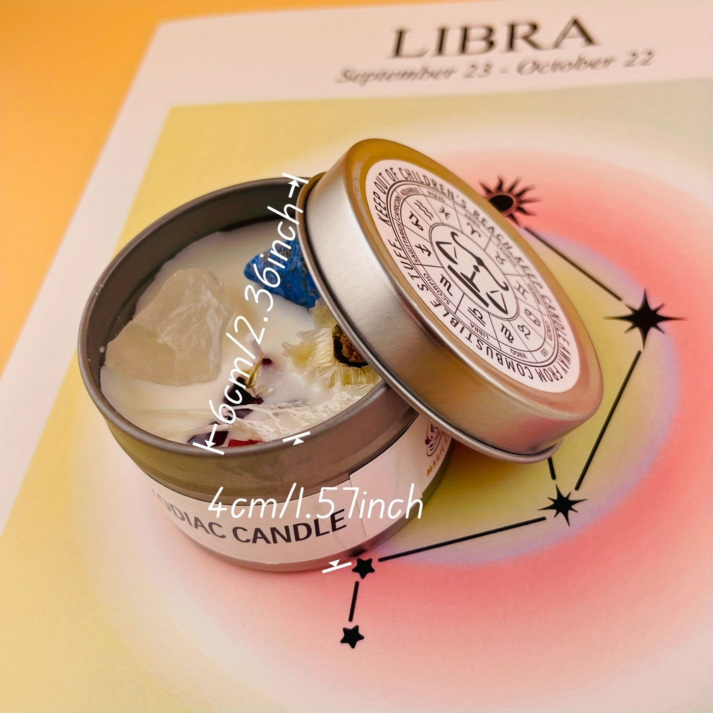 Decorative candle in a tin with Libra zodiac design on a colorful background