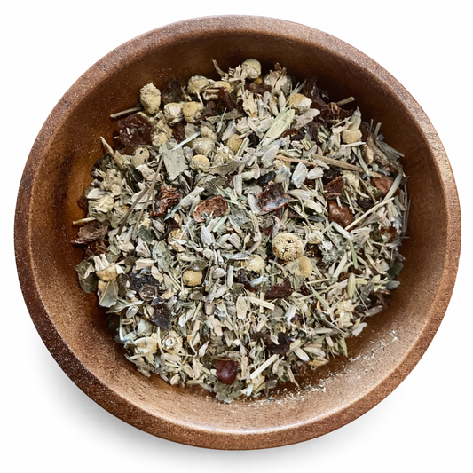 Anti-Anxiety Herbal tea mix in a wooden bowl on a white background. -Clover's Charm