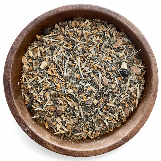 Anti-inflammatory herbal tea in a brown ceramic bowl on a white background. -Clover's Charm