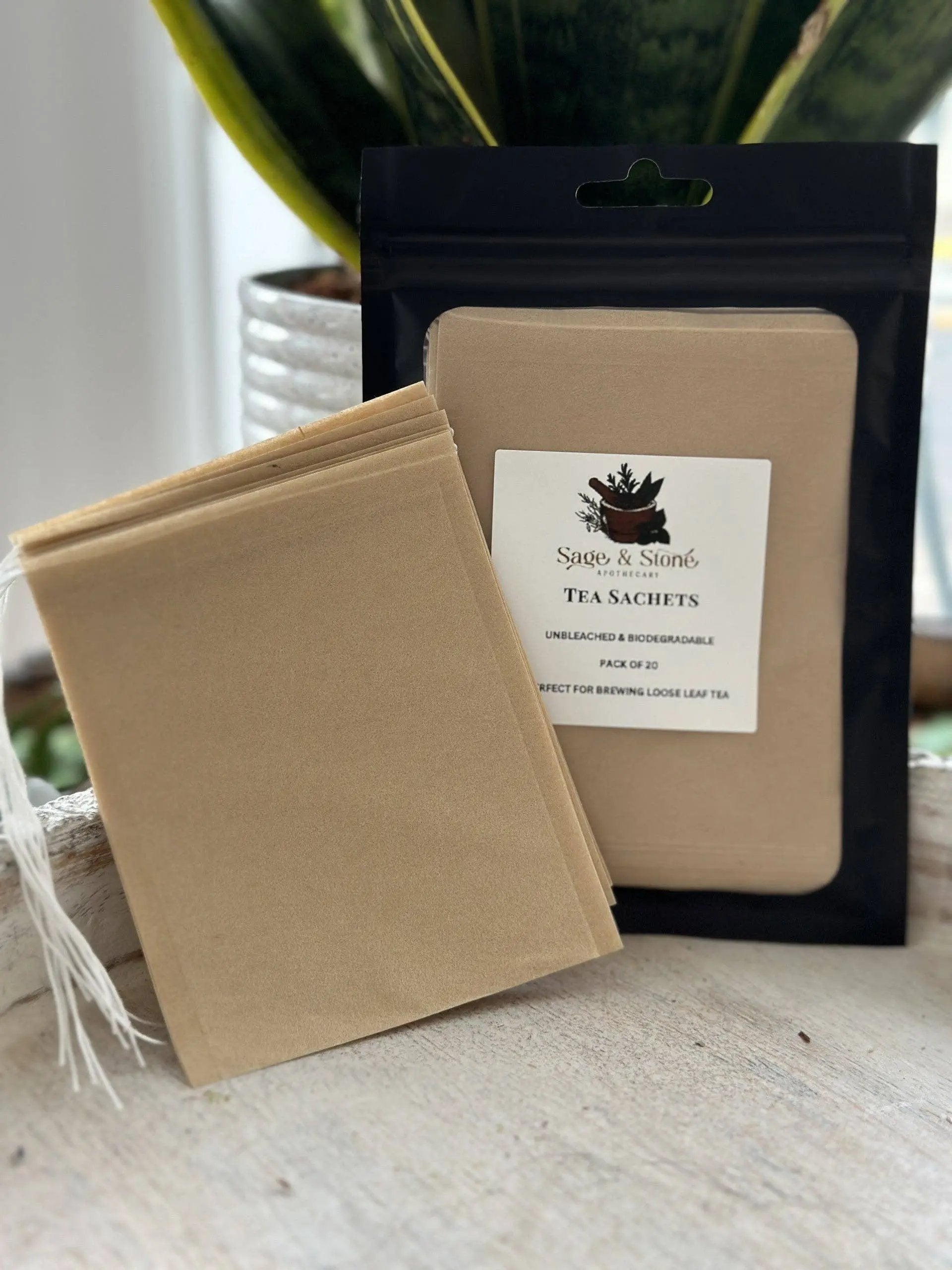 Tea sachets with a branded label on a light surface. -Clover's Charm