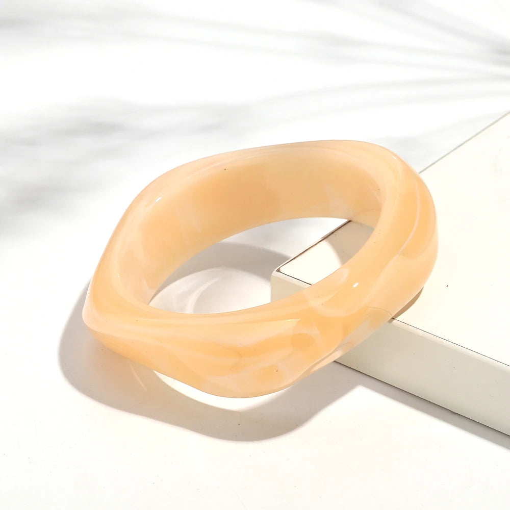 Beige bangle on a white surface