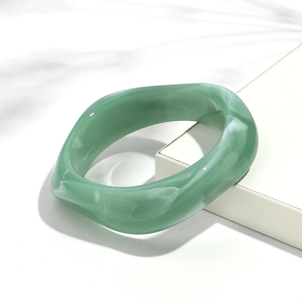 Green jade bracelet on a white surface