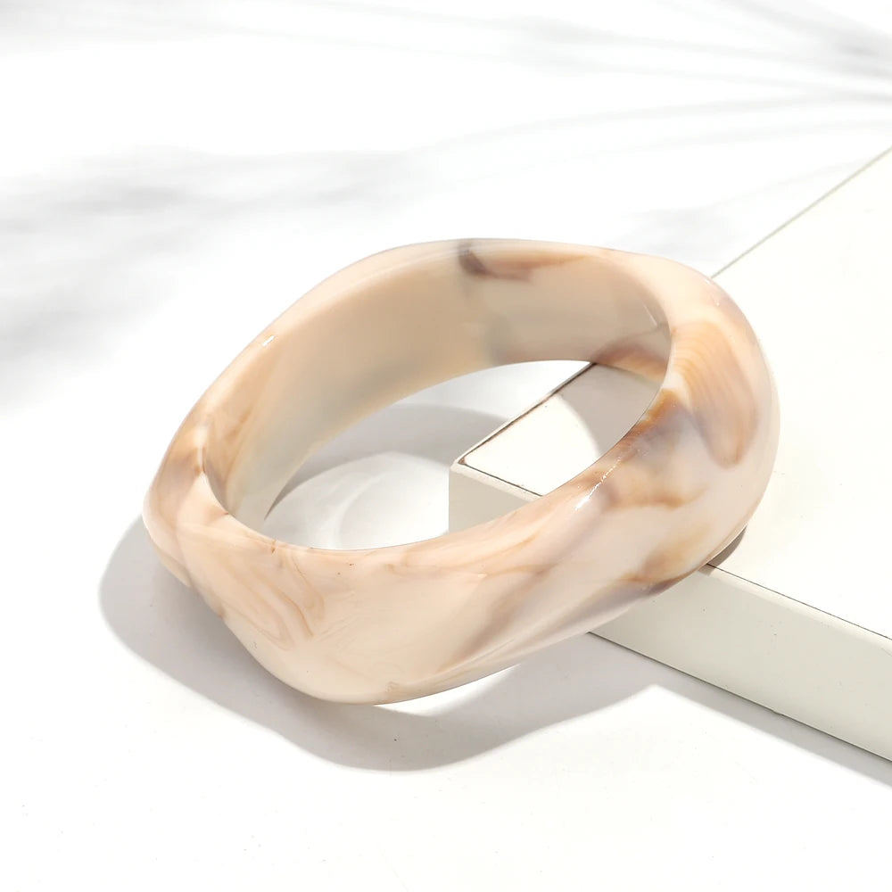 Marbled beige bangle on a white surface