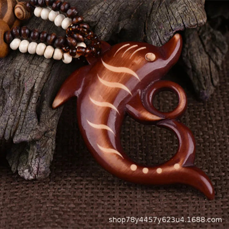 Wooden fish-shaped ornament on a textured brown background