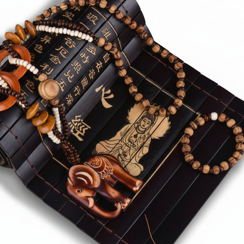 Decorative object with Buddhist symbols, elephant figure, and text on a white background