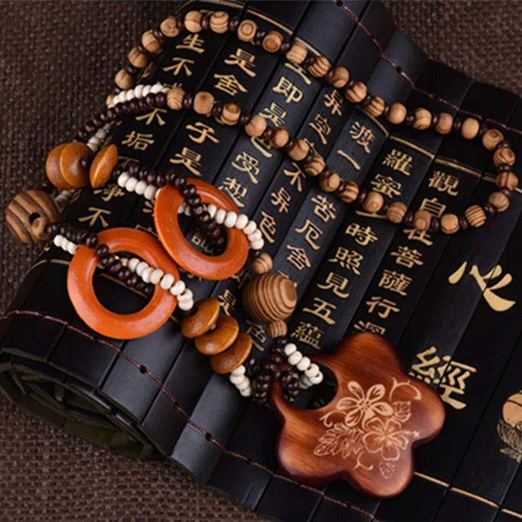 Beaded keychains with wooden floral elements on a textured surface