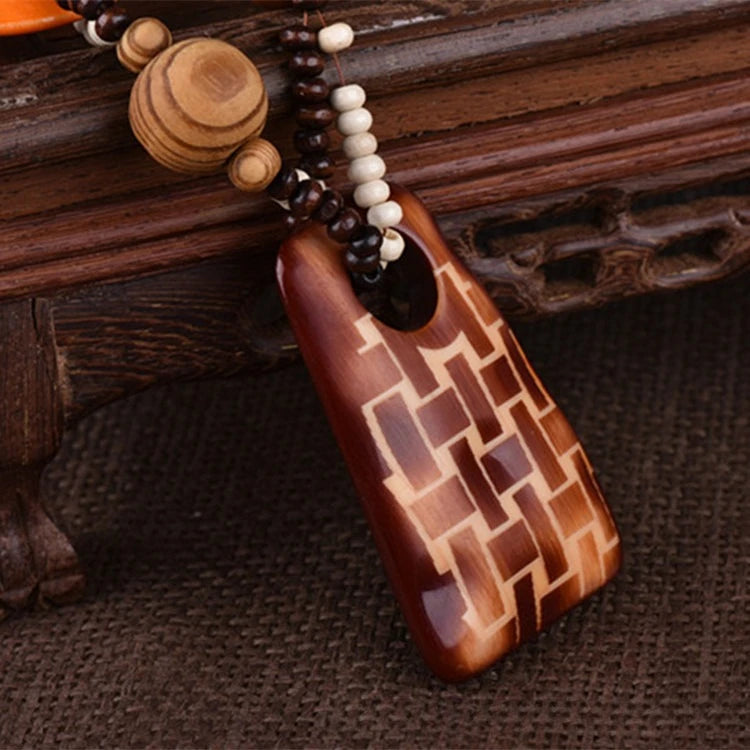 Decorative pendant with beads on a textured brown surface