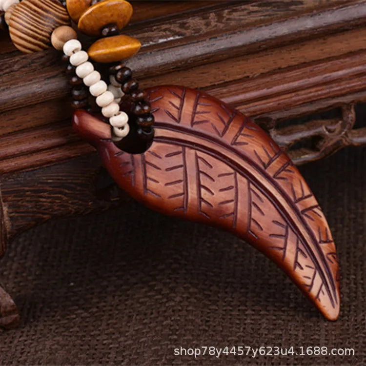 Wooden carvings with leaf patterns on a textured wooden surface