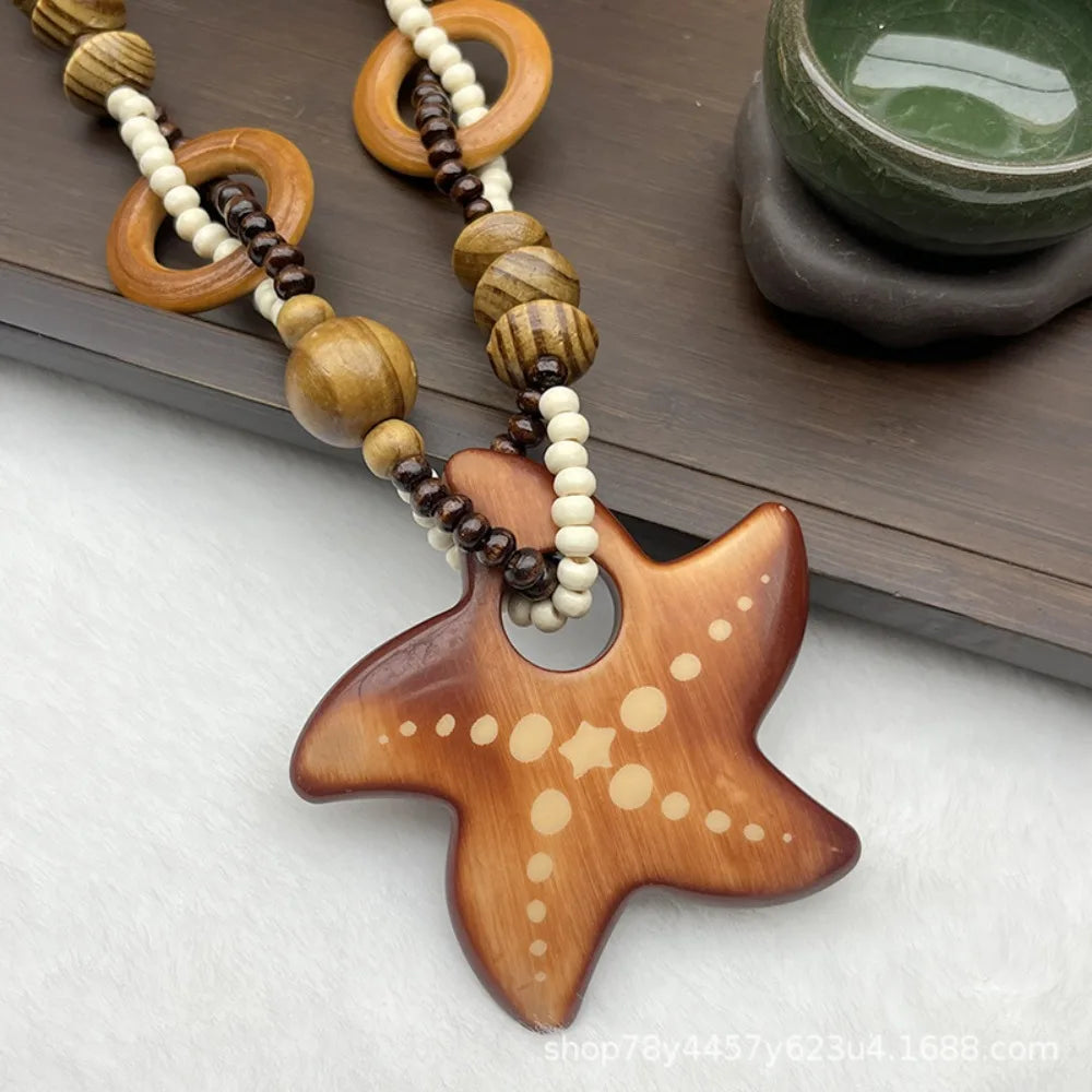Wooden starfish pendant necklace with beads on a wooden surface