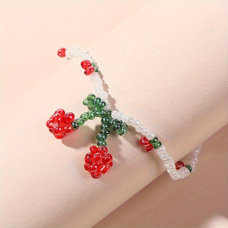 Cherry Beaded Bracelet with Red, Green & White Mini Beads – Elegant Alloy Design on a tube display