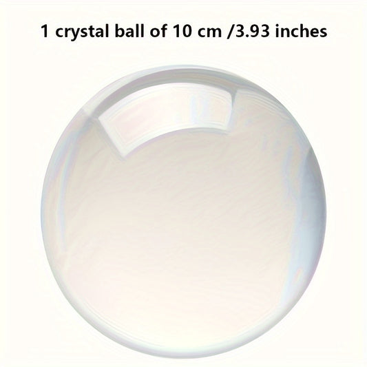 Clear glass sphere on a beige cushion against a white background