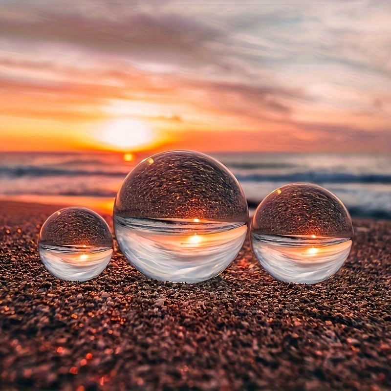 Three crystal balls on a beach at sunset
