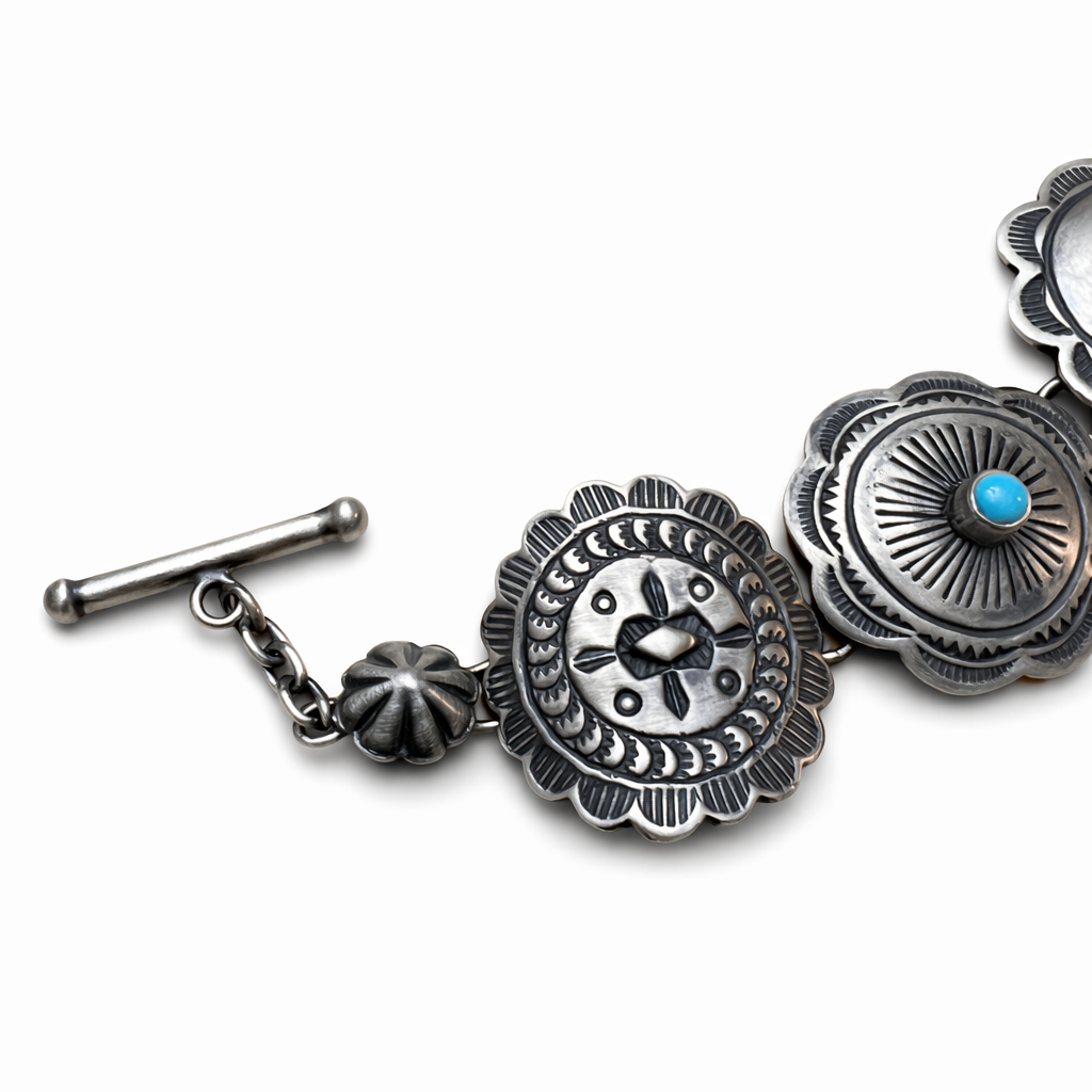 A closeup view of a toggle clasp, aka T-bar clasp, sterling silver Concho link bracelet with Sleeping Beauty turquoise stones on a white background toggle clasp