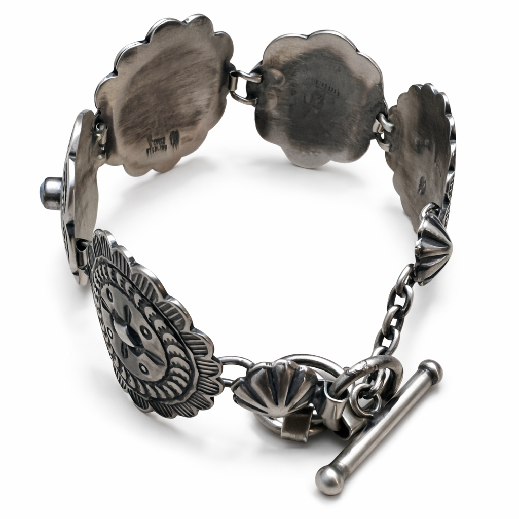 A  T-bar clasp sterling silver Concho link bracelet on a white background.