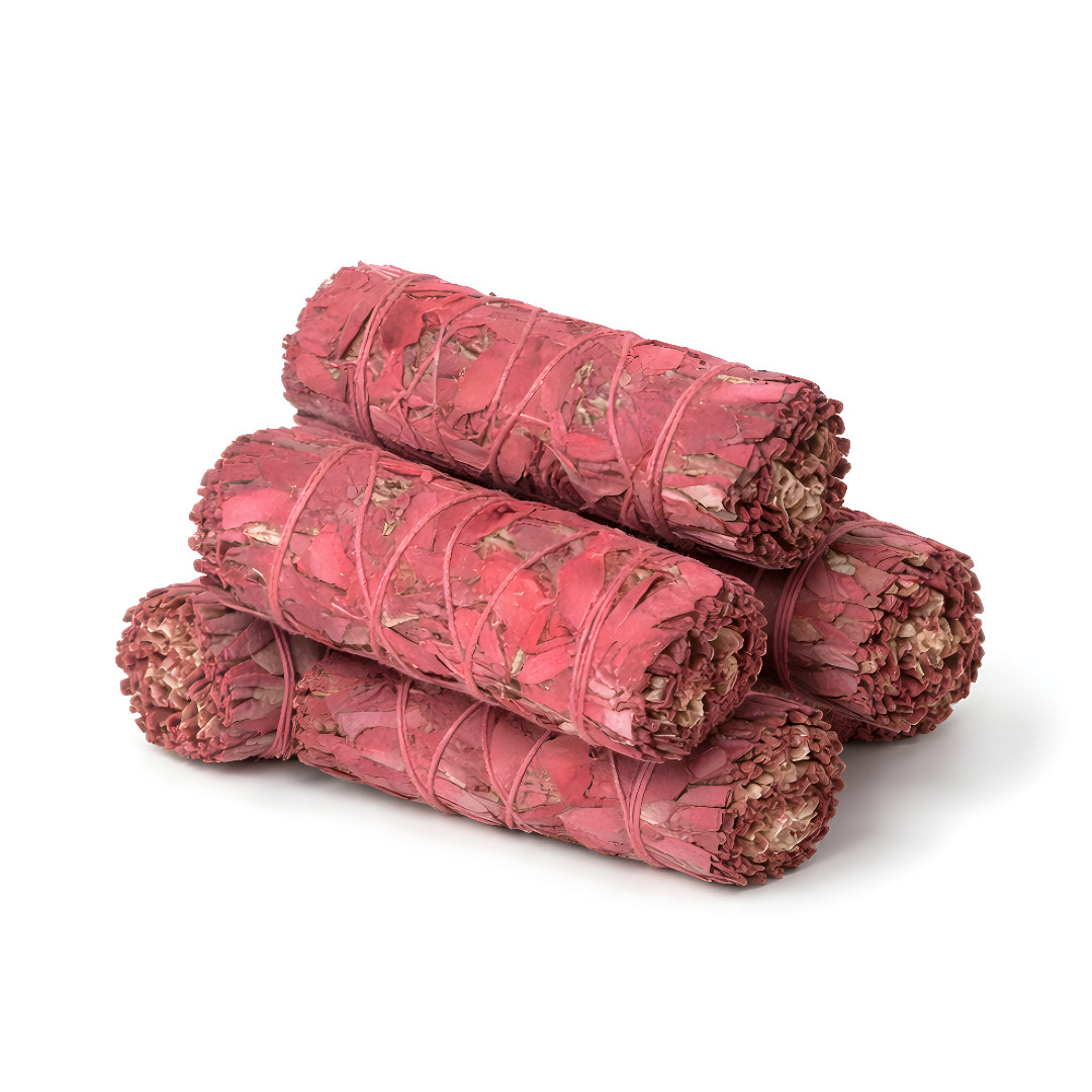 Stack of Dragon's Blood sage smudge sticks wrapped with natural twine and dried petals, arranged in a compact pile on a pure white background.