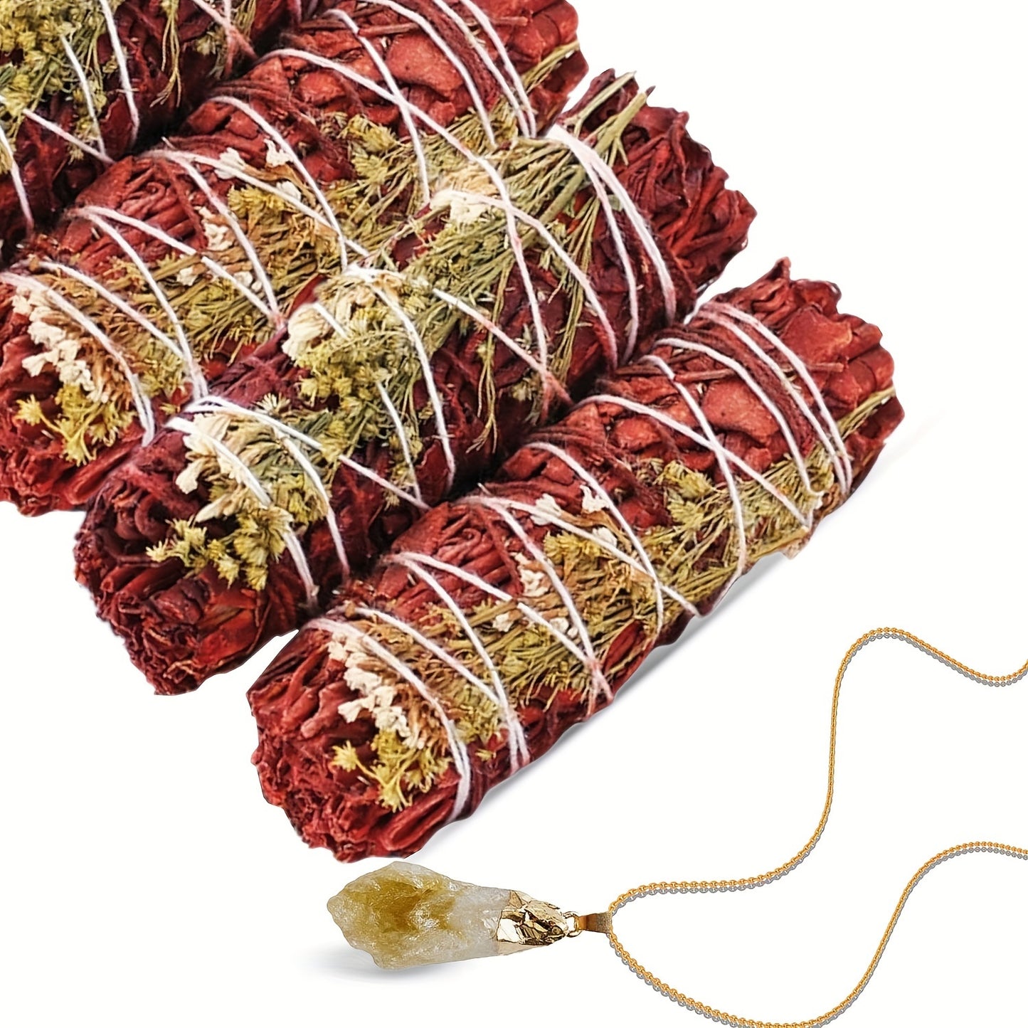 Two bundles of red and gold sage smudge sticks with a crystal pendant on a white background