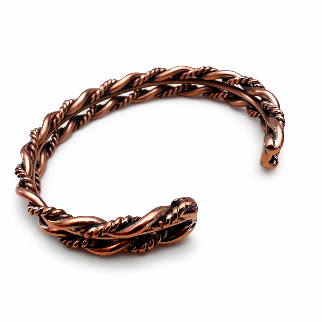 The back view of an Elaine Tahe copper twist cuff bracelet with multi wire Navajo twist design on a white background.