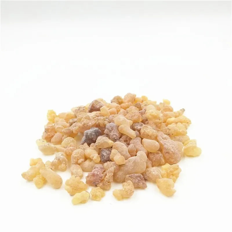 Heap of amber-colored resin on a white background