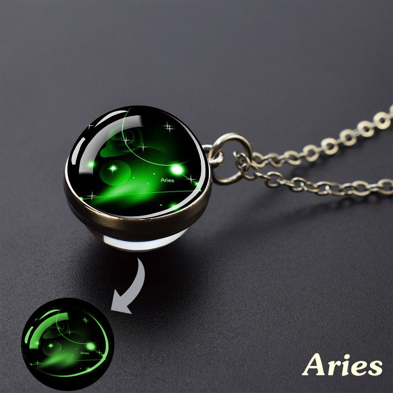 Necklace with a glowing green Aries zodiac pendant on a dark background