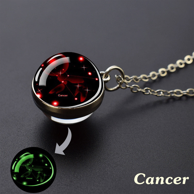 Necklace with Cancer zodiac sign pendant on a dark background