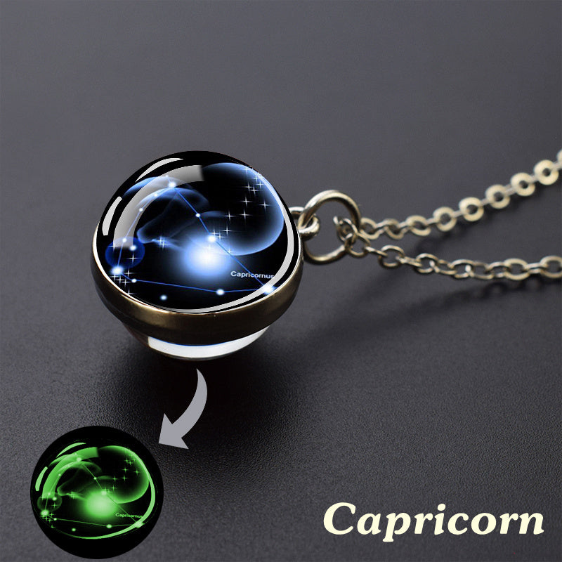 Necklace with a zodiac pendant labeled 'Capricorn' on a dark background