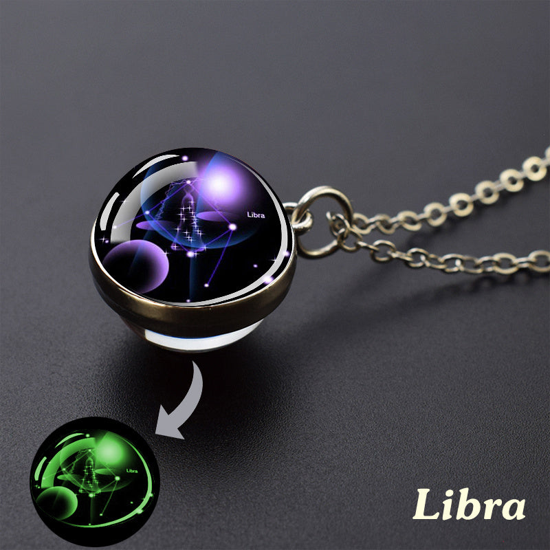 Necklace with a zodiac pendant labeled 'Libra' on a dark background