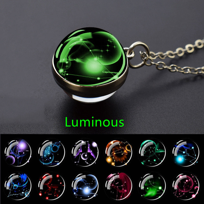 Luminous pendant with zodiac design on a dark background displaying a collection of constellation options
