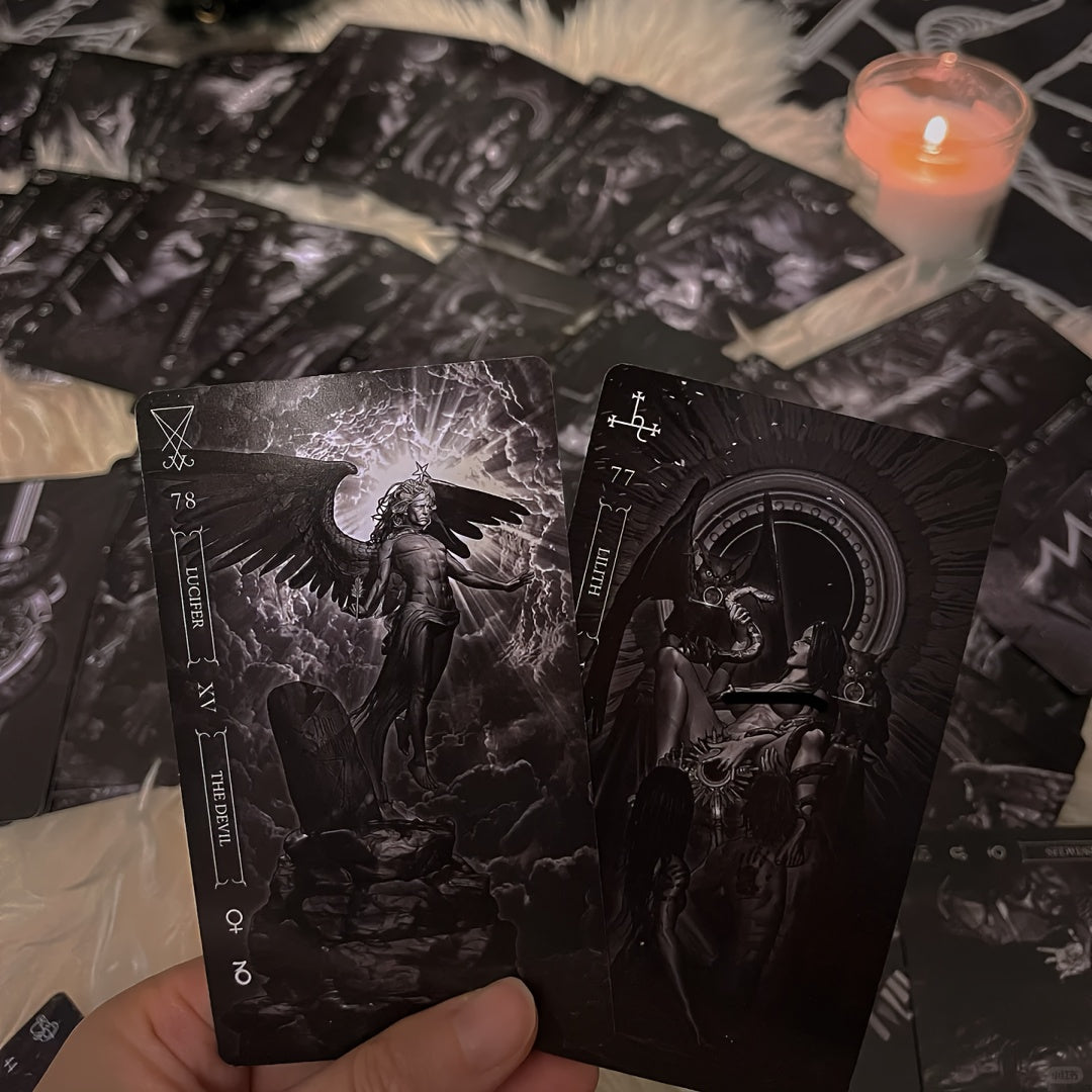 Two tarot cards held in front of a spread with candles on a dark background