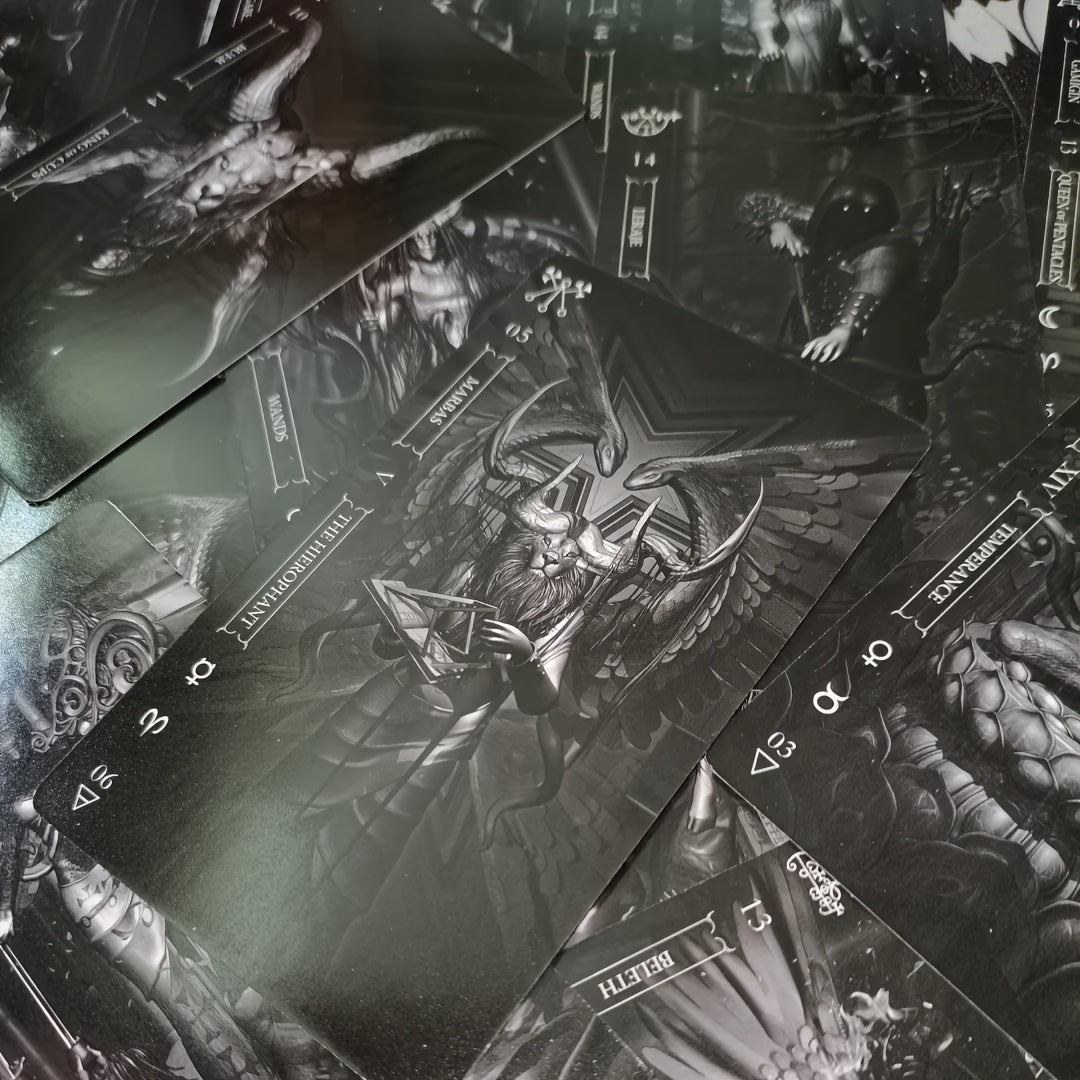 Collection of black and white tarot cards with detailed illustrations on a dark background.