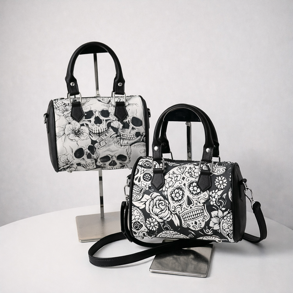 Gothic skull print purse displayed on stand with structured handles